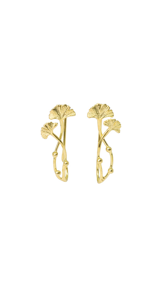 Gold leaf-shaped earrings on a white background
